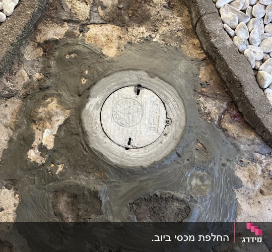 תיקון מכסה ביוב עם בטון על שביל אבנים